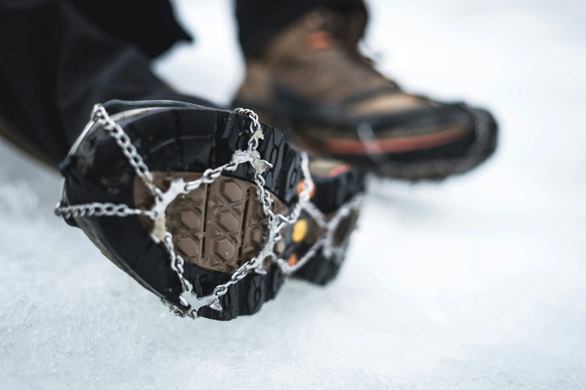 Ice cleates fitted on bottom of Hiking boots